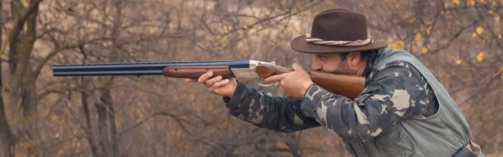 How to hunt coyotes with a shotgun - Hunter shooting a shotgun